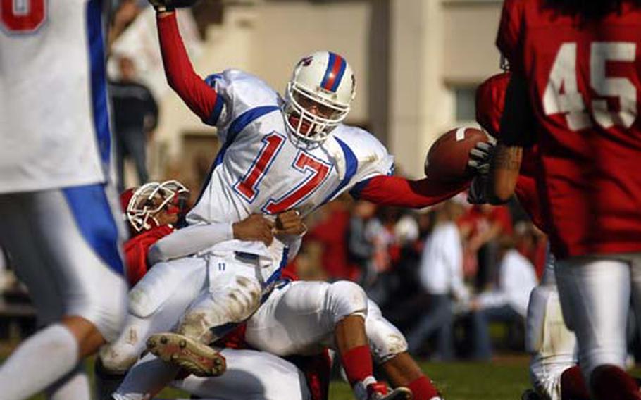 Ramstein&#39;s Evan Canfield, a senior, signals touchdown after breaking into the end zone Saturday during a Division I match-up against Kaiserslautern in Vogelweh. Canfield scored two touchdowns in Ramstein&#39;s 20-7 victory, which gave the Royals the D-I North title and a home berth in the upcoming D-I playoffs.