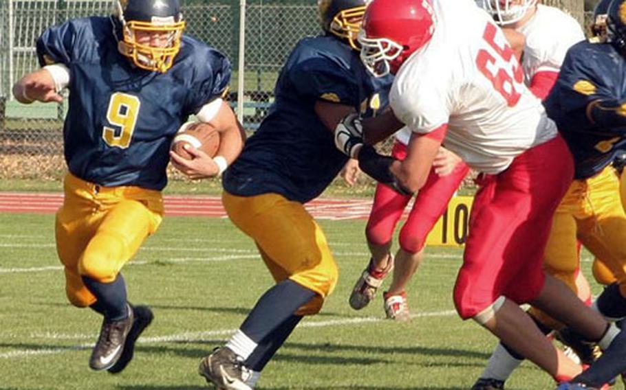 Heidelberg’s Kyle Ulses tries to go wide on one of his 19 carries Saturday during the Lions’ 41-14 Division I semifinal against Kaiserslautern. Trying to get to Ulses is Kaiserslautern senior Sayf Kone (65).