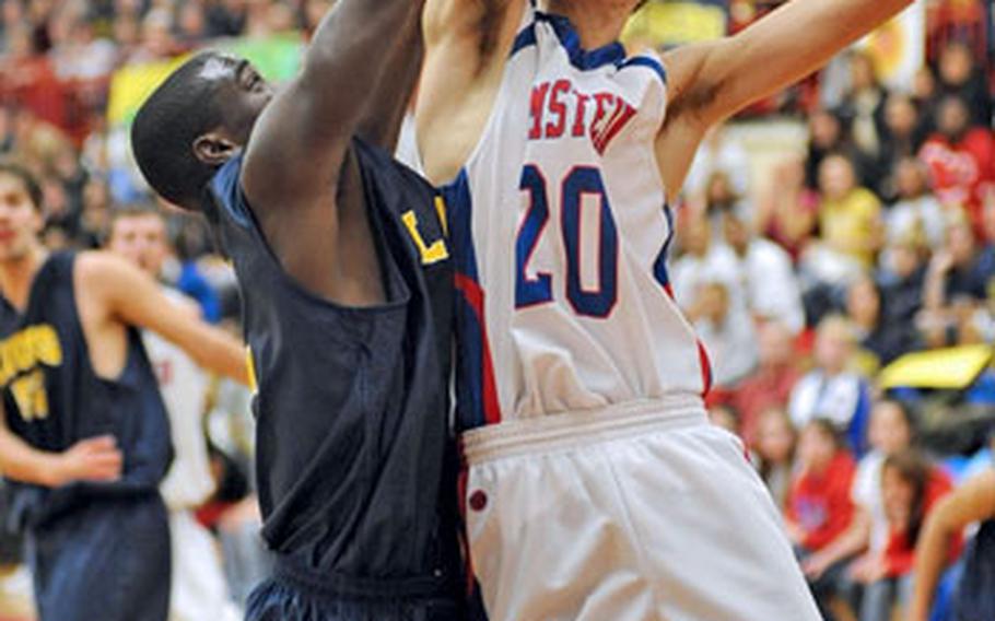 Ramstein&#39;s Dillon Wadsack, right, goes to the hoop against Heidelberg&#39;s Eugene Jones in the boys Division I final of the DODDS-Europe basketball championships in Mannheim, Friday night. Ramstein captured the Division I crown with a 53-47 win and Wadsack was named the tourney MVP.