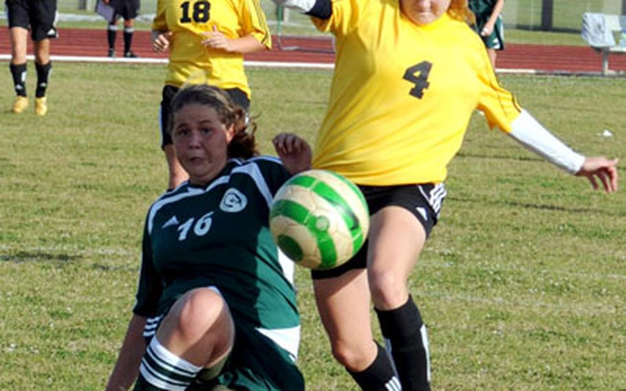 Kubasaki freshman sweeper Sydnie Bligh (16) sends the ball away from Kadena senior striker Cassie McDonald during Friday&#39;s match at Camp Foster, Okinawa. Kubasaki won in a penalty-kick shootout and swept the three-match regular-season series.