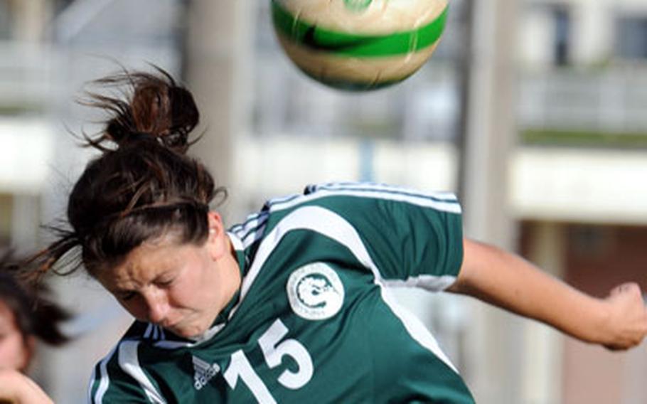 Kubasaki sophomore fullback Nicole Bossert heads the ball away from the net against Kadena during Friday&#39;s match.