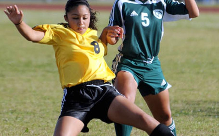 Kadena junior midfielder Tyler Arrieta (8) slides to keep the ball away from Kubasaki senior Cait Frandsen during Friday&#39;s match.