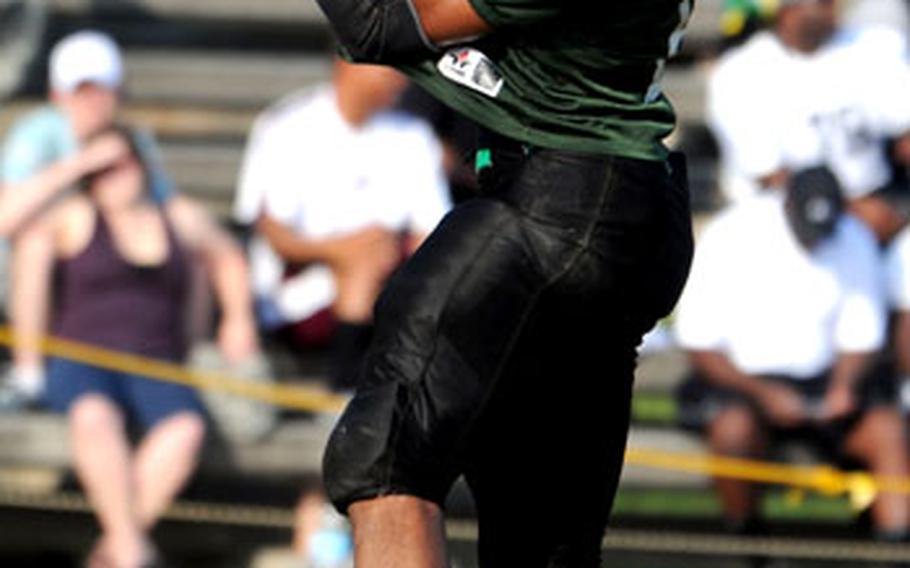 Kadena Dragons receiver Andre Warren hauls in a pass against the Yokosuka Seahawks during Saturday&#39;s U.S. Forces Japan-American Football League season-opening game at Kadena Air Base, Okinawa. Yokosuka rallied for a last-second 15-12 win.