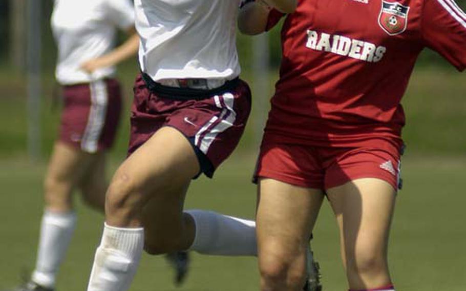 Vilseck senior Shamyra Coleman, left, tangles with Ariana Eoff of Kaiserslautern Wednesday on opening day of the DODDS-Europe Division I soccer championship. Coleman led Vilseck to a 3-0 victory over Kaiserslautern in the Division I match.