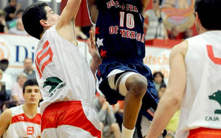 Spain&#39;s Jordi Mas, left, tries to keep Kevin Ware of the United States from scoring in the Americans&#39; 91-81 victory over Spain at the Albert Schweitzer tournament Wednesday night. Ware was the top scorer for the U.S. with 22 points.