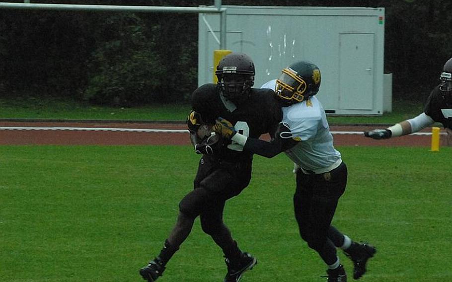 Vilseck's Cedrell Sanders tries to break free of the Heidelberg defense Saturday during Heidelberg's 14-0 win Saturday in Vilseck. Sanders was the leading rusher for Vilseck with 42 yards on 9 carries.