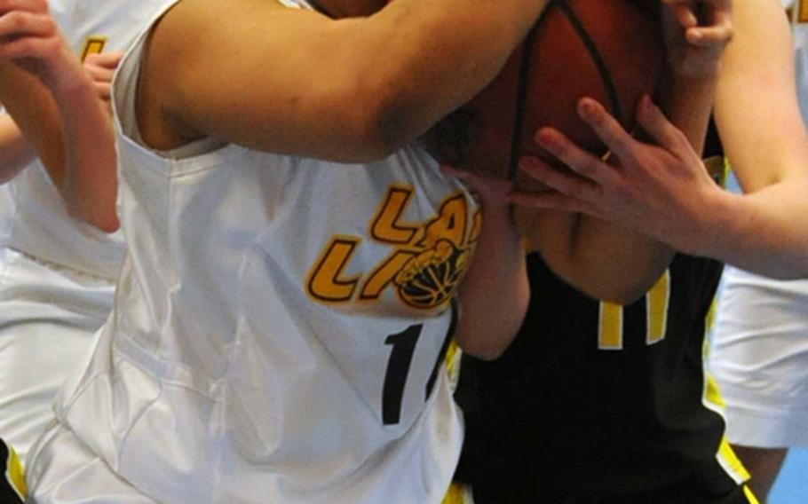 Heidelberg's Aysa Tucker, left, and Patch's Johanna Quinn fight for a ball in Patch's 56-39 win over the Lady Lions in Heidelberg on Saturday.