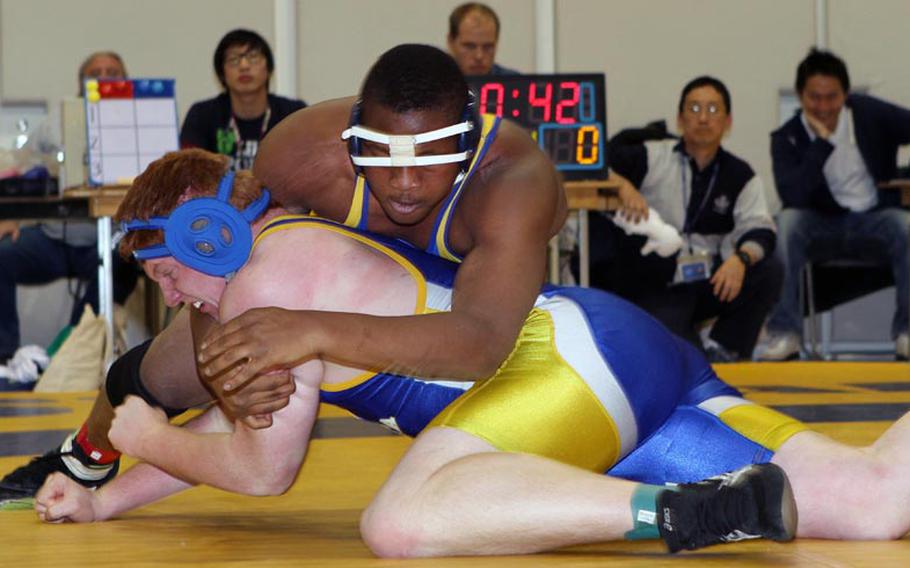 St. Mary's heavyweight Chidi Agbo gets the upper hand on Yokota's Jesse Hogan during Saturday's Kanto Plain Association of Secondary Schools wrestling finals at St. Mary's International School, Tokyo. Agbo, one of four reigning Far East tournament gold medalists, pinned Hogan in 2 minutes, 55 seconds.