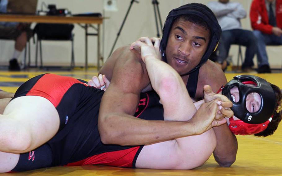 Zama American 180-pounder Mitchell Harrison wrenches the shoulders of Nile C. Kinnick's Aaron Stravers to the mat during Saturday's Kanto Plain Association of Secondary Schools wrestling finals at St. Mary's International School, Tokyo. Harrison pinned Stravers in 3 minutes, 34 seconds.