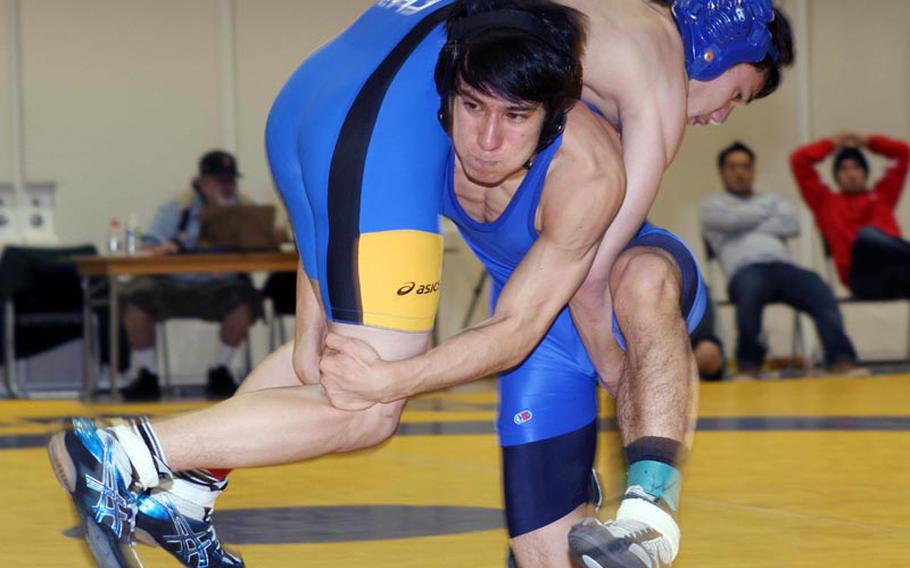 St. Mary's 129-pounder Soma Yoshida tries to lift Christian Academy Japan's Yuma Fuseya during Saturday's Kanto Plain Association of Secondary Schools wrestling finals at St. Mary's International School, Tokyo. Fuseya won by two-period decision 4-1, 4-2 over Yoshida, one of four reigning Far East tournament gold medalists, and improved to 3-0 against Yoshida this season. Fuseya was voted the tournament's Outstanding Wrestler by the coaches.