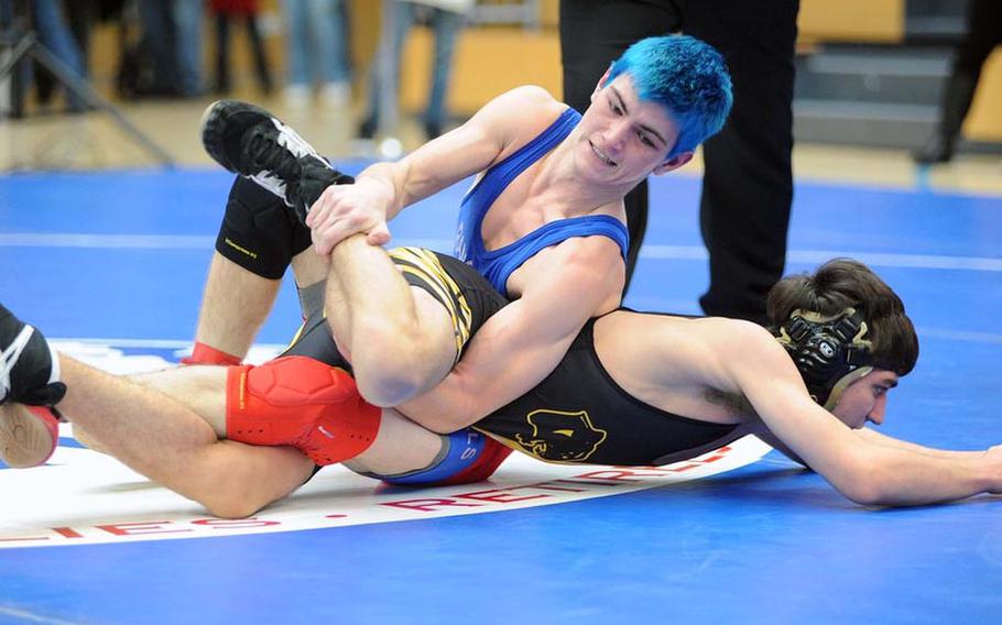 Ramstein's Mitchell Shafer, top, ties up Patch's Chris Brown in their 120-pound match on opening day of the DODDS-Europe wrestling championships in Wiesbaden, Friday. Shafer won with a 8-4 decision.