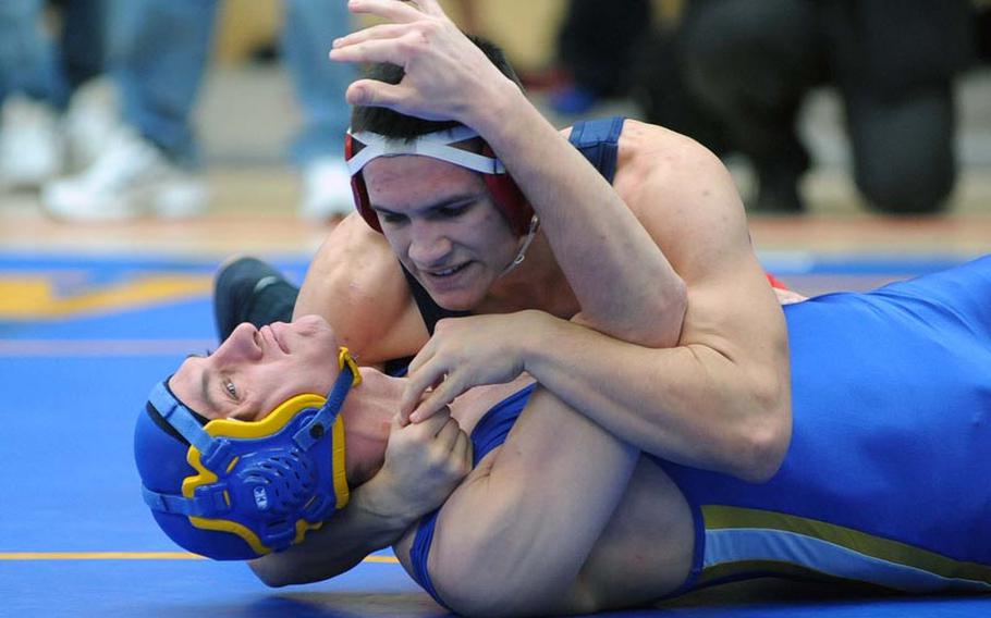 Wiesbaden's John Spiszer, left, tries to get out of Adam Carroll's grip in their 145-pound match. The Lakenheath wrestler won the opening day match at the DODDS-Europe wrestling championships in Wiesbaden Friday with a fall at 1:00.