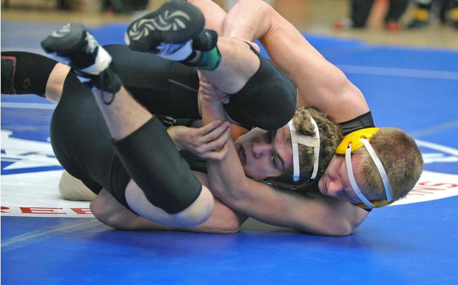 Patch's J.C. Rapp, right, has AFNORTH's Cullen Ennis in his grasp as he goes on to win the 170-pound match with a fall in 40 seconds on opening day of the DODDS-Europe wrestling finals in Wiesbaden, Friday.