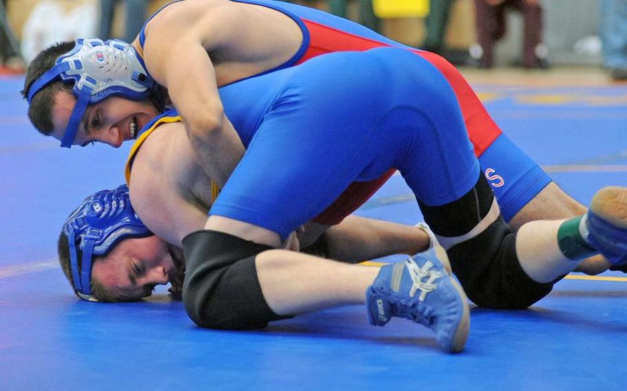 Ramstei's Steve Cavanaugh, top, grapples with Sigonella's Daniel Vossler in opening day action at the DODDS-Europe wrestling championships in Wiesbaden, Friday. Cavanaugh won the 106-pound match with a major decision 13-5.