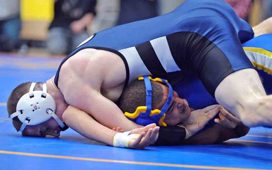 Bitburg's John Downey pressures Jessie Davis of Wiesbaden to the mat in their 160-pound match at the DODDS-Europe wrestling championships. Downey won on an 8-4 decision.