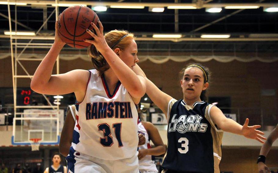 Ramstein's Katherine Enyeart tries to advance the ball to a teammate as Heidelberg's Kylee Miller defends during the Division I championship game Saturday in Wiesbaden, Germany. Heidelberg won the game 32-31.