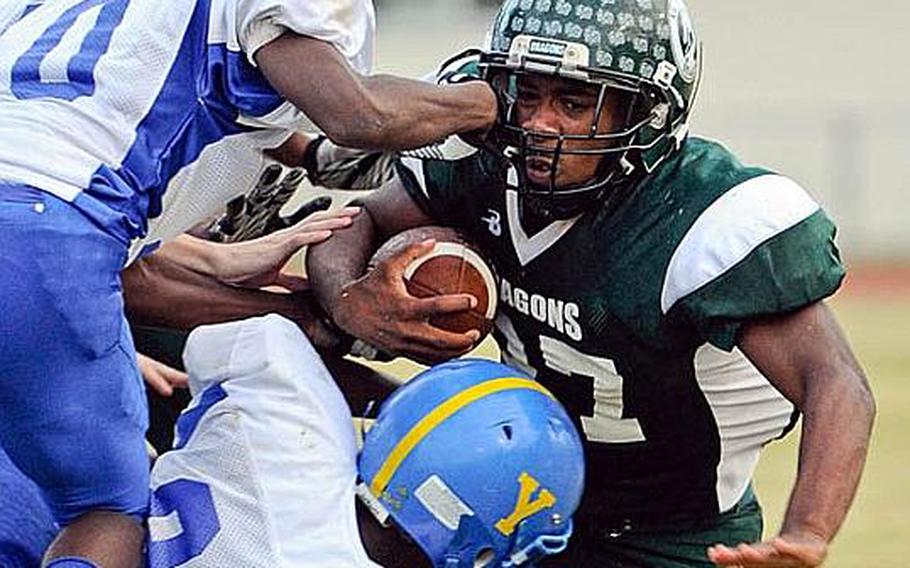 Kubasaki return man Tyshon Butler gets chopped down by Yokota coverage men J.J. Henderson, left, and Ke'Ondre Davis during Saturday's DODDS Pacific Far East Division I football game at Camp Foster, Okinawa. Yokota won 31-6.