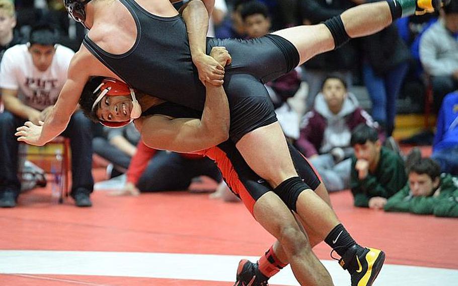 Nile C. Kinnick's Darius Swenson lifts and scores a two-point throw on Matthew C. Perry's Andrew Borrero in the 158-pound final during the 25th Nile C. Kinnick Invitational "Beast of the Far East" Wrestling Tournament. Swenson beat Borrero by decision 9-6.