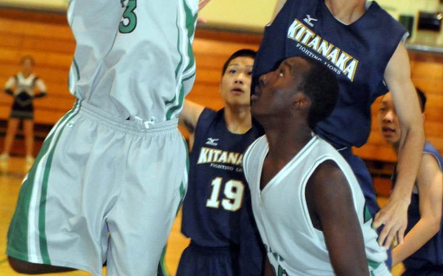 Kubasaki guard DaQuan Alderman drives to the basket past Kitanakagusuku's Shogo Matayoshi and Yoshito Ishimine during Tuesday's boys high school basketball game at Camp Foster, Okinawa. The host Dragons beat the Fighting Lions 81-68.