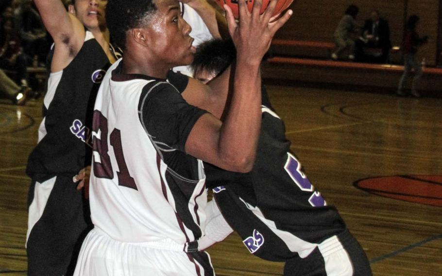 Matthew C. Perry's Jarell Davis looks to shoot against two Senri-Osaka International defenders during Friday's boys high school basketball game at Marine Corps Air Station Iwakuni, Japan. The Samurai beat the Sabres 53-38.