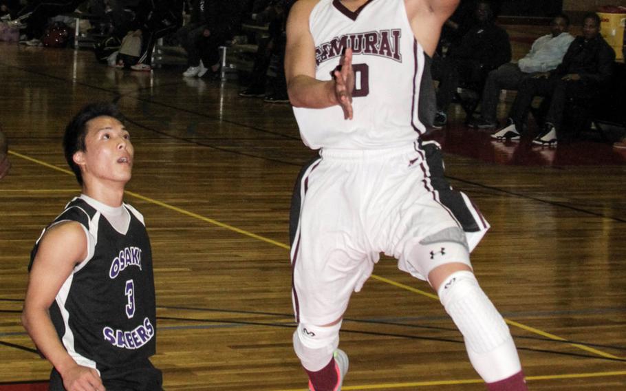 Matthew C. Perry's Jon Cadavos shoots over Senri-Osaka International defender Taishi Miki during Friday's boys high school basketball game at Marine Corps Air Station Iwakuni, Japan. The Samurai beat the Sabres 53-38.