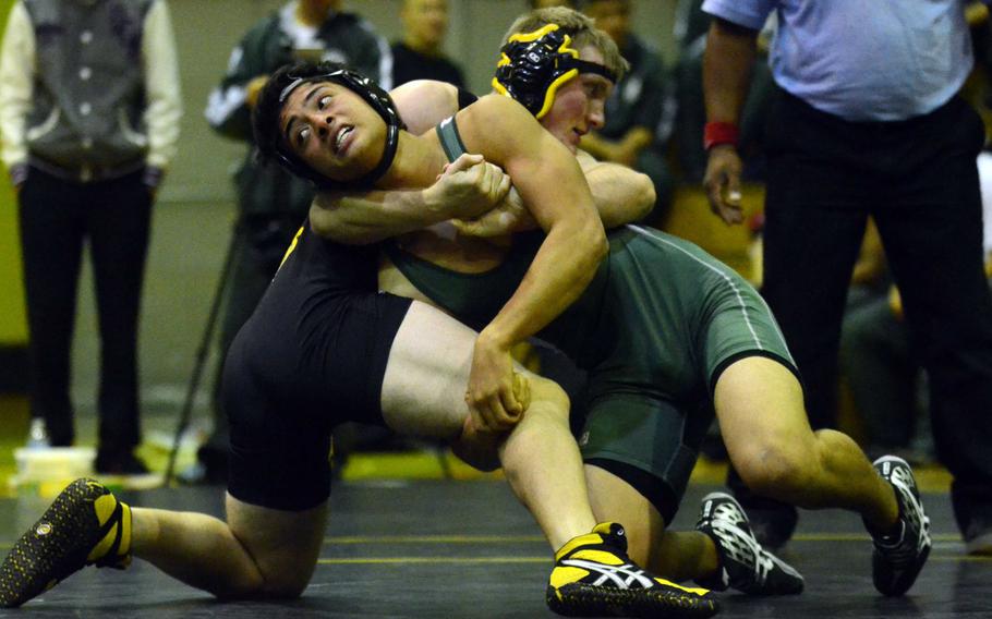 Kubasaki's Sho Green and Kadena's James Alexander battle for the advantage in the 168-pound bout during Wednesday's Okinawa Athletics and Activities Council high school wrestling meet at Kadena Air Base, Okinawa. Alexander pinned Green in 3 minutes, 35 seconds, but Kubasaki won the dual meet 42-16.