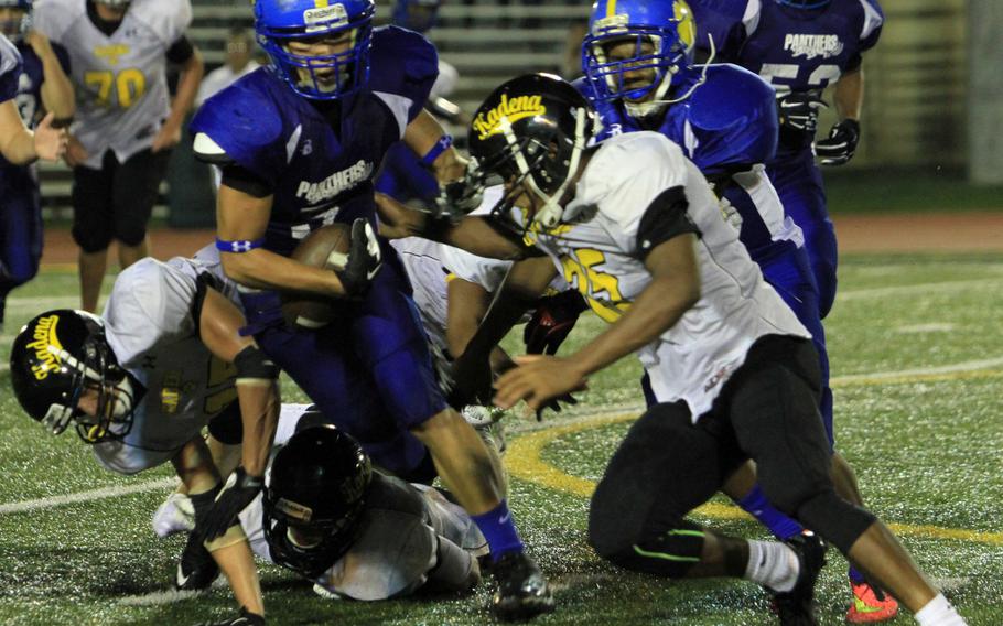 Yokota running back Shota Sprunger is about to be taken down by a host of Kadena defenders led by Jason Bland, center, in the Okinawa-based Panthers 41-13 victory Friday night over their counterparts from Japan.