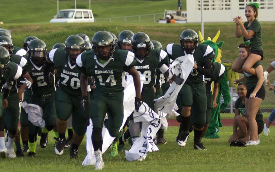 Kubasaki players, led by senior running back Winston Maxwell enter the field before Friday's game with Kadena. The defending Far East Division I champion Dragons rallied to edge the Panthers 28-25.