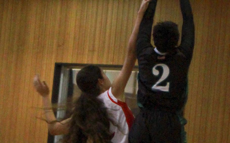 Daegu's Cameron Black goes up for a shot against Okinawa Christian
defender Amal Martinez on Tuesday during a day 2 double-elimination playoff game at the Far East basketball tournaments. Okinawa Christian won 33-28.
