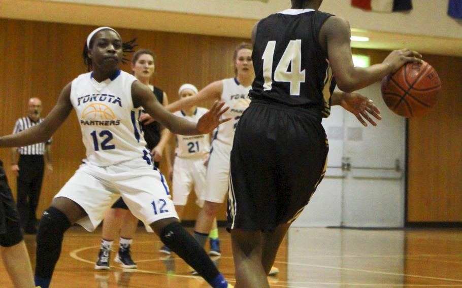 Humphreys' Ja'Asia RaSun looks for an opening around Yokota defender Jamia Bailey on Tuesday during a day 2 double-elimination playoff game at the Far East basketball tournaments. Yokota won 42-18.