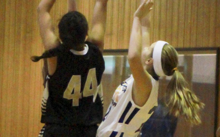 Humphreys' Sydney Wilson takes a shot against Yokota defender Paige Gall on Tuesday during a day 2 double-elimination playoff game at the Far East basketball tournaments. Yokota won 42-18.
