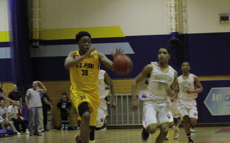 Matthew C. Perry's Jarrell Davis receives a pass ahead of Yokota defender Jadan Anderson during a day 2 Far East  basketball tournament game Tuesday.