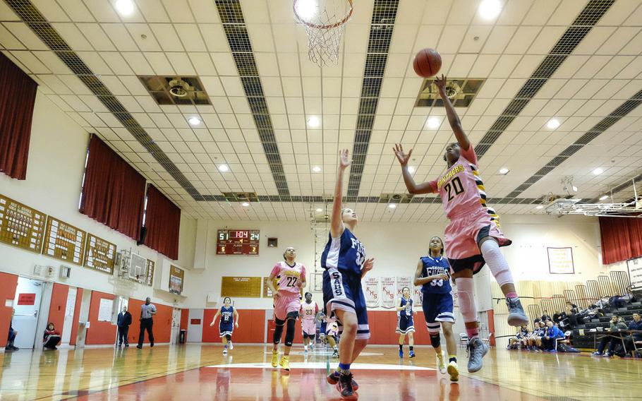 Kadena's Brenda Gulley finishes a fast break past Seoul American defenders Charley Smith, left, and Shaniquawa Jackson during round-robin play of the girls' Division I Far East Tournament at Naval Base Yokosuka, Japan on Tuesday, Feb. 17, 2015. Kadena will play Kubasaki in Wednesday's semifinal. 