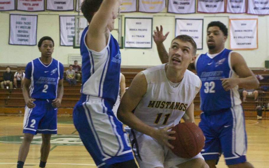 American School in Japan's Brandon Rogers tries to score against Seoul American's Max Weekley.