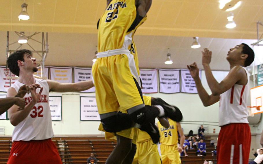 Kadena's Jamario Harris soars for the ball against Nile C. Kinnick.


