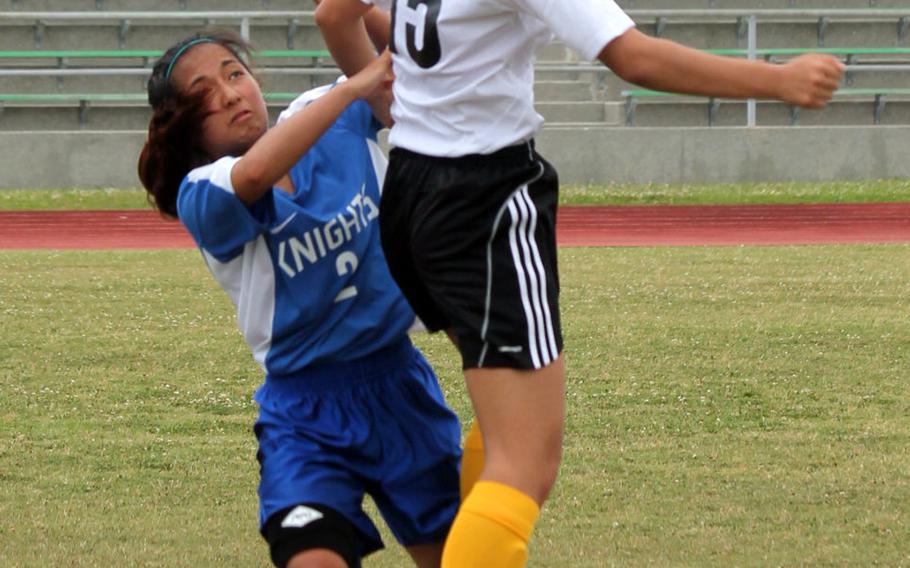 American Sschool In Japan's Erin Chang and Christian Academy in Japan's Abi Climacosa try to play the ball during the Mustangs' 9-0 win in girls D-I soccer action.