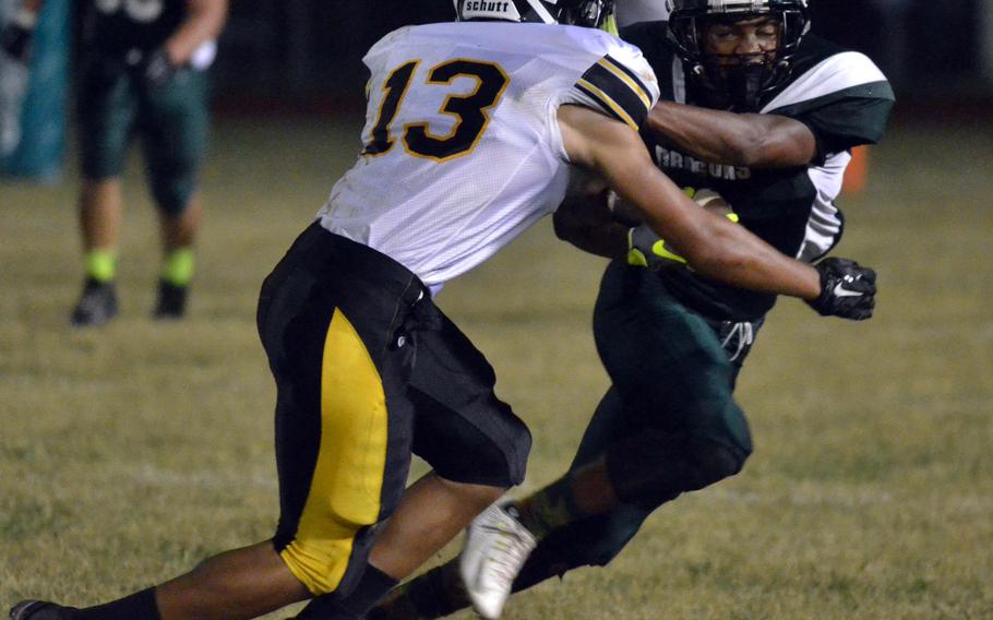 Kubasaki's Jacob Green tries to evade the tackle of Kadena's Donte Savoy.