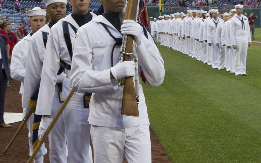 The U.S. Navy Ceremonial Guard marches onto the field on U.S. Navy Day at Nationals Park in Washington, D.C., May 3, 2017.