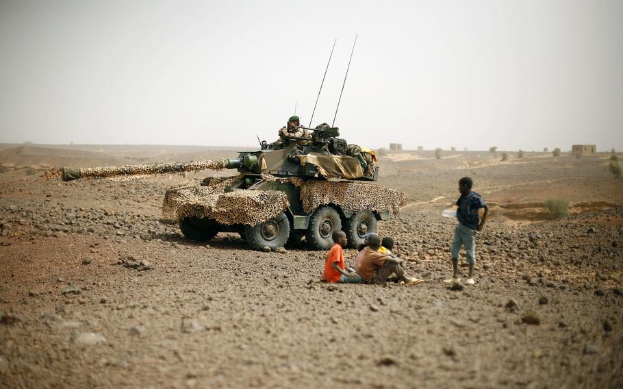 African children gather around a French tank in Mali..