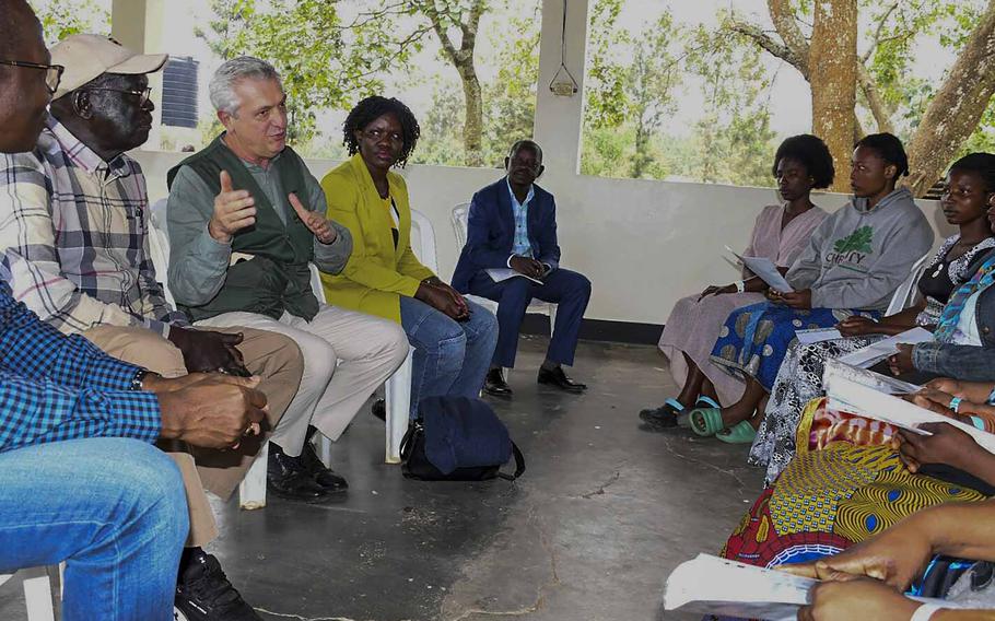 U.N. High Commissioner for Refugees (UNHCR), Filippo Grandi, third left, gestures as he talks with refugees at Rwamwanja Refugee Settlement in Kamwenge District, Uganda, on Oct. 21, 2024. 