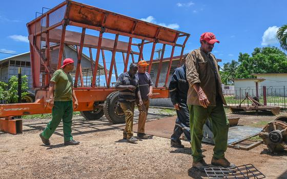 Workers take a break due to lack of electricity at the Rigoberto Corcho Basic Unit of Cooperative Production, dedicated to the production of sugar cane, livestock and construction materials, in Artemisa province on June 27, 2024, in Cuba. 