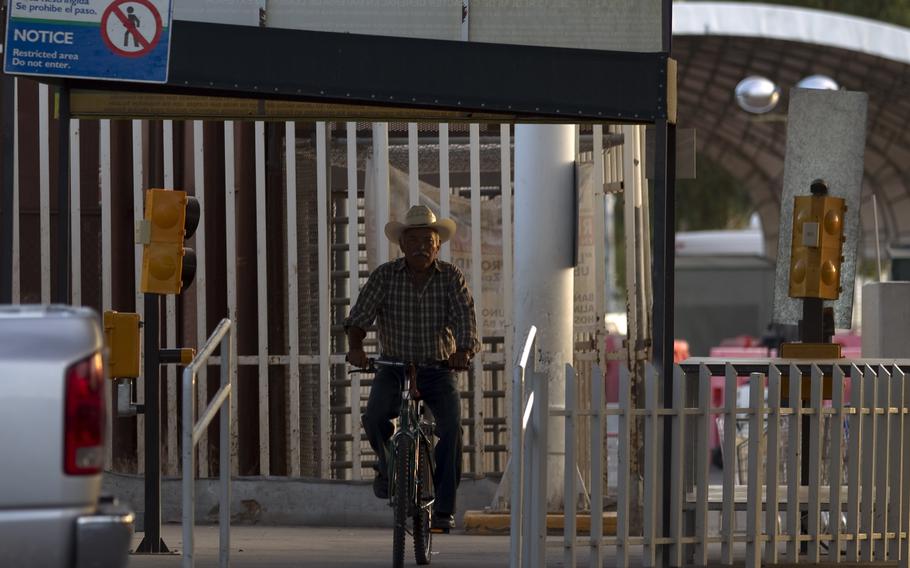 A man rides his bike through the Mexican port of entry in San Luis Rio Colorado, Mexico, July 29, 2010.  