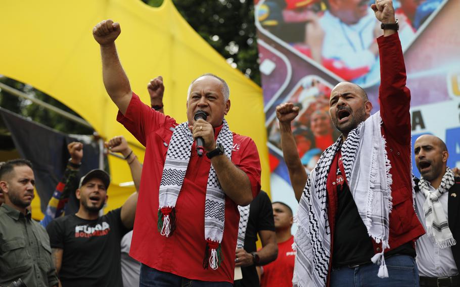 Venezuelan Interior Minister Diosdado Cabello, left, and Palestinian Ambassador to Venezuela Maher Taha, take part in a rally celebrating the July 28 reelection of President Nicolas Maduro, in Caracas, Venezuela, Saturday, Sept. 28, 2024. 