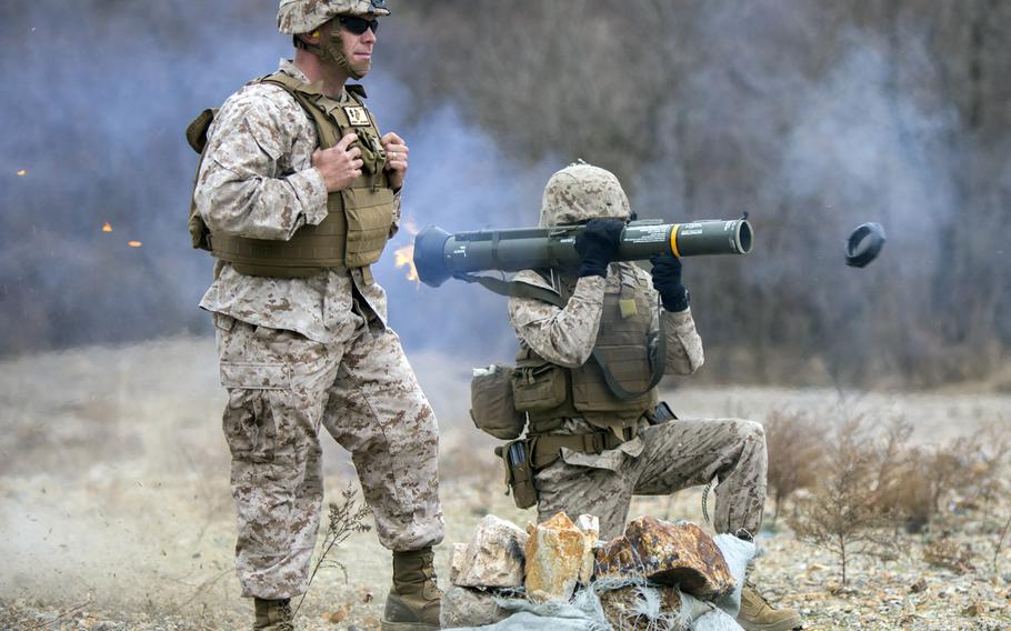 U.S. Marine Corps Cpl. Lloyd Burton III, field artillery cannoneer, with A Battery, 1st Battalion 12th Marines, 3rd Marine Division, fires an M136E1 AT4-CS confined space light anti-armor weapon at a live fire training event during Exercise Ssang Yong 14 at Suesongri, South Korea, March 26, 2014.