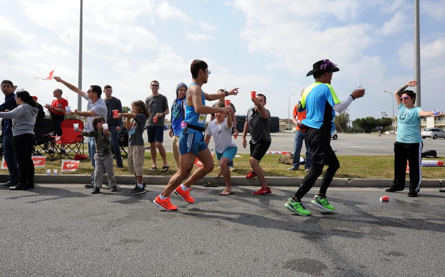 Volunteers hand out water and cheer the runners during the 2015 Okinawa Marathon on Kadena Air Base, Japan, on Feb. 15, 2015. This was the 23rd year Kadena opened its gates for marathon runners.

Zackary A. Henry/U.S. Air Force