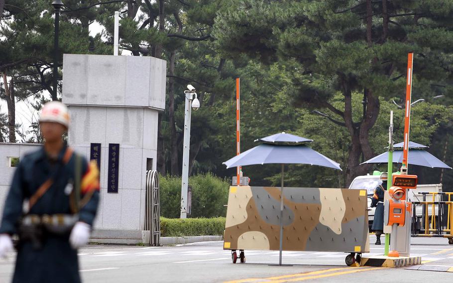 A South Korean navy servicemember stands guard at a naval base in Jinhae, South Korea, Tuesday, Aug. 16, 2016. An accidental explosion happened during repair work on a submarine at a naval base in the southeast of the country, South Korean officials said.