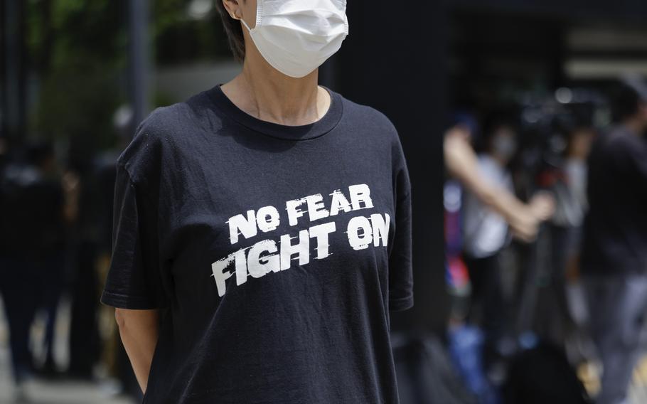 A member of the public stands outside the District Court in Wan Chai, Hong Kong, ahead of a sentencing hearing for two former Stand News editors convicted of sedition, Thursday, Sept. 26, 2024. 