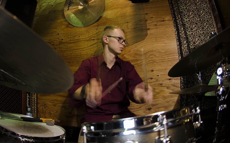 Andrew Clemenson, a member of The Sky Kings Saxophone Quartet, plays drums with the group at Cafe de Noel near Yokota Air Base, Japan, Friday, Nov. 30, 2018.