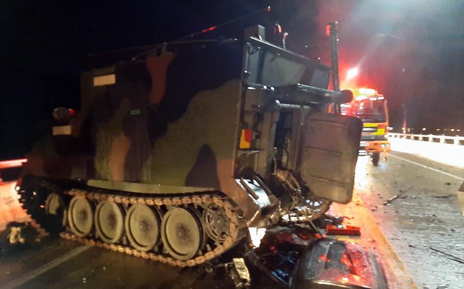 Emergency workers tend to the scene after a collision involving a U.S. armored personnel carrier and a civilian SUV that killed four South Koreans near the Rodriguez Live-Fire Complex in Pocheon, South Korea, Sunday, Aug. 30, 2020. 