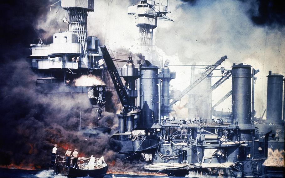 In this Dec. 7, 1941 file photo, a small boat rescues a USS West Virginia crew member from the water after the Japanese bombing of Pearl Harbor, Hawaii.